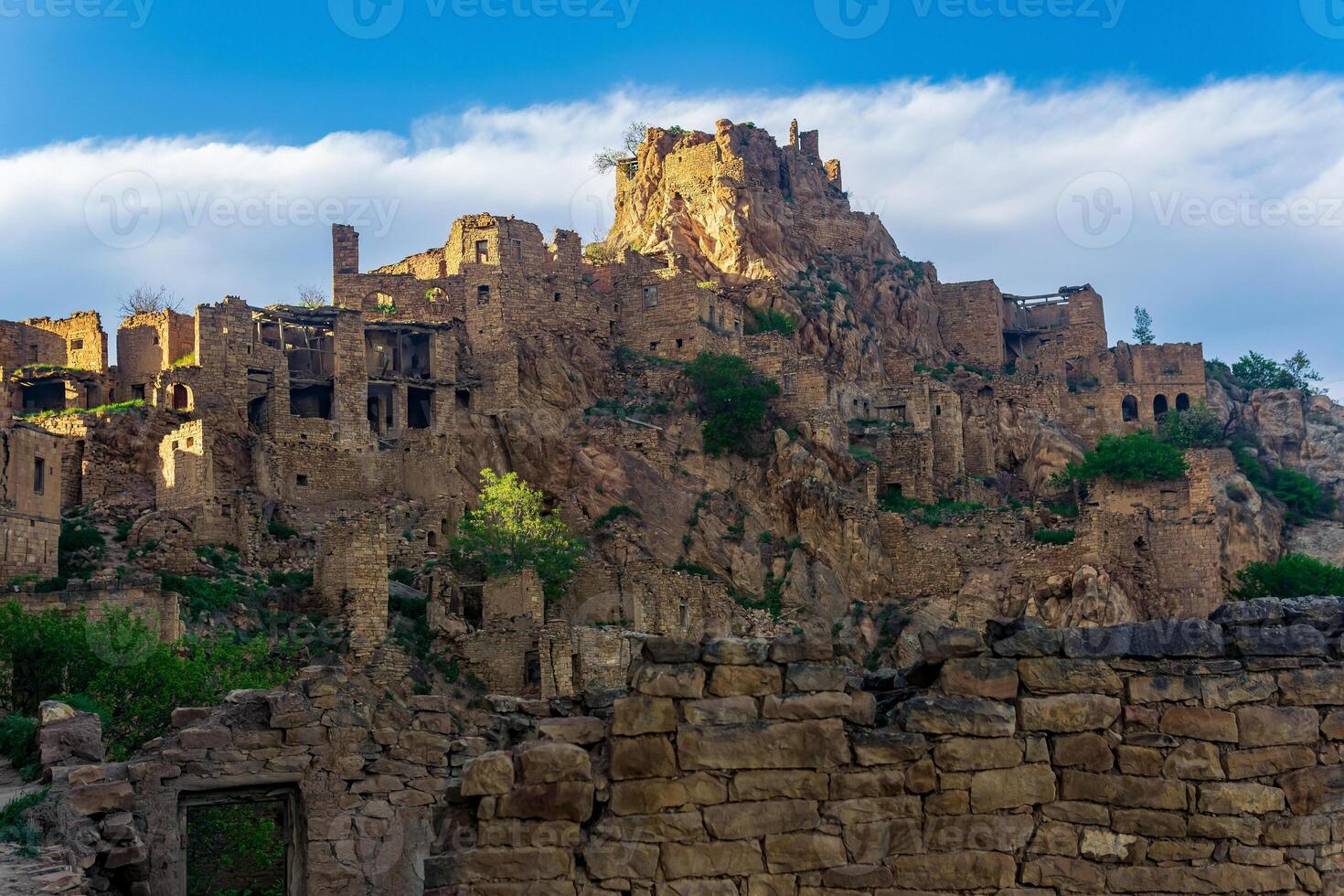 evening view of the uninhabited village of Gamsutl on top of a mountain in Dagestan photo