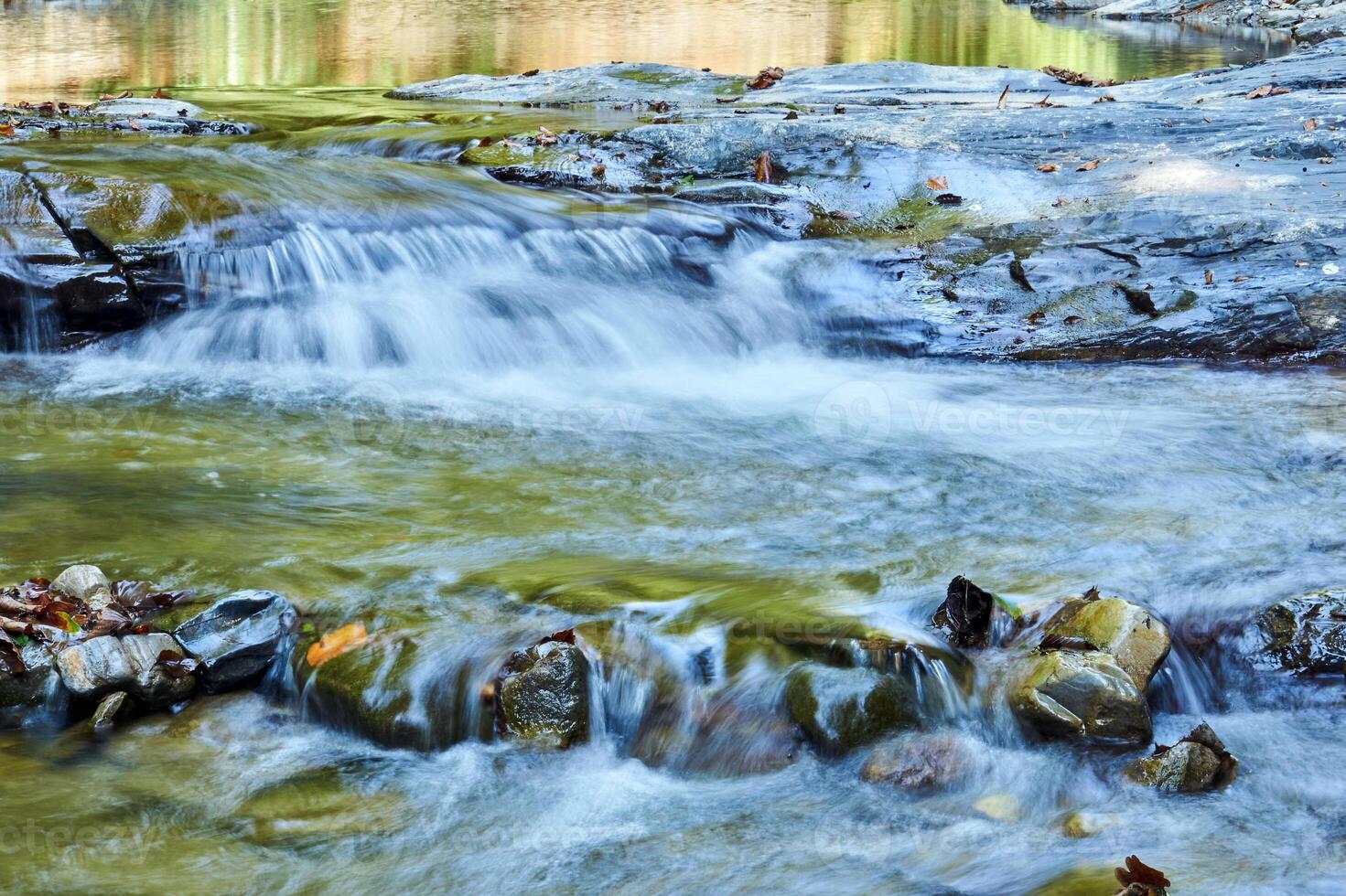 cascade of rapids on a shallow mountain river photo