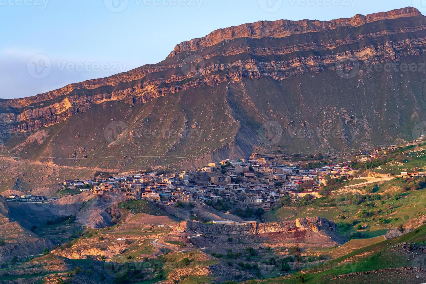 evening view of the mountain village of Chokh in Dagestan on the slope of a vast valley photo