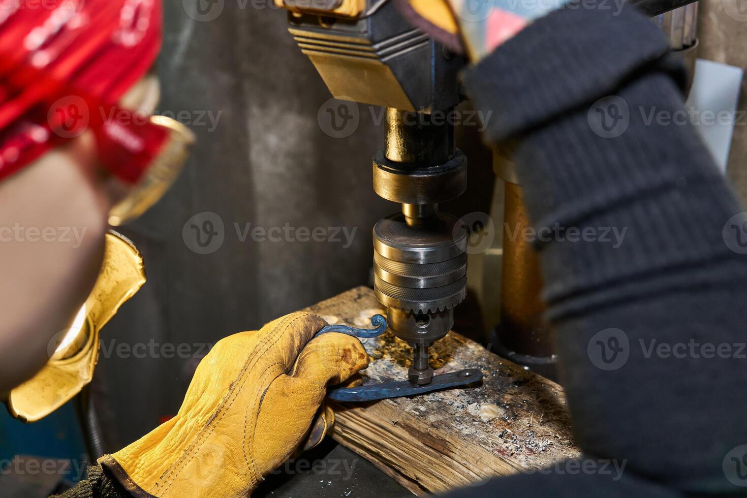 female artisan works on a drilling machine with a countersink close-up photo