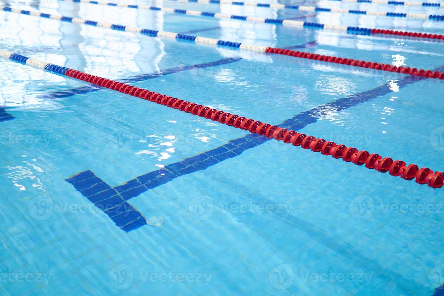 fragment of the competition pool with blue water and marked swimming lanes photo