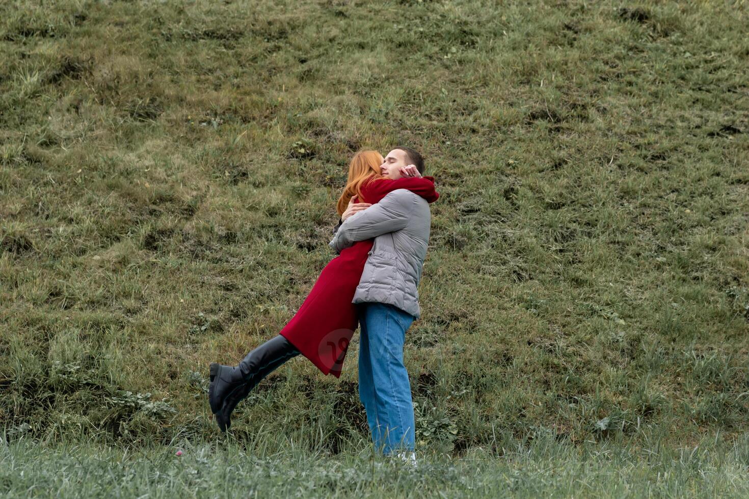 lovers meeting, man and woman hugging outdoors photo