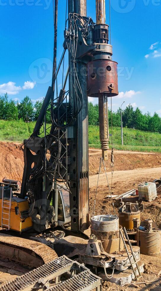 machine for drilling deep piles is preparing to work on the construction of the bridge photo