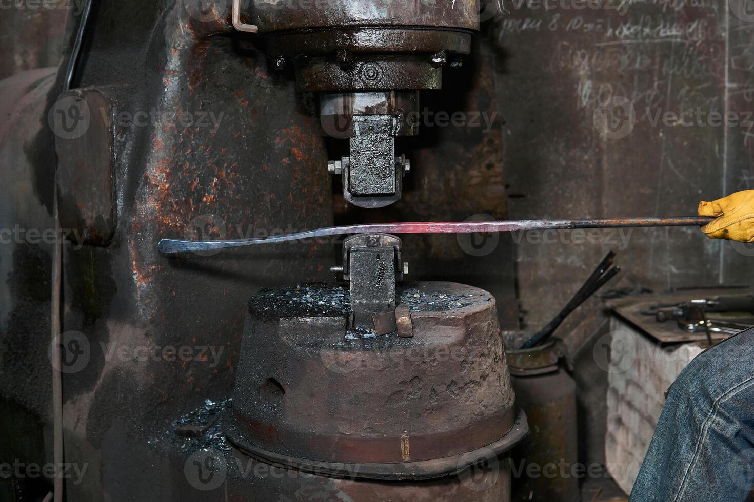 processing of a hot workpiece with a power forge hammer, close-up photo