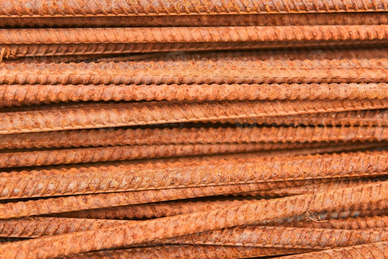 background - rusty reinforcing bars piled in a heap close-up photo