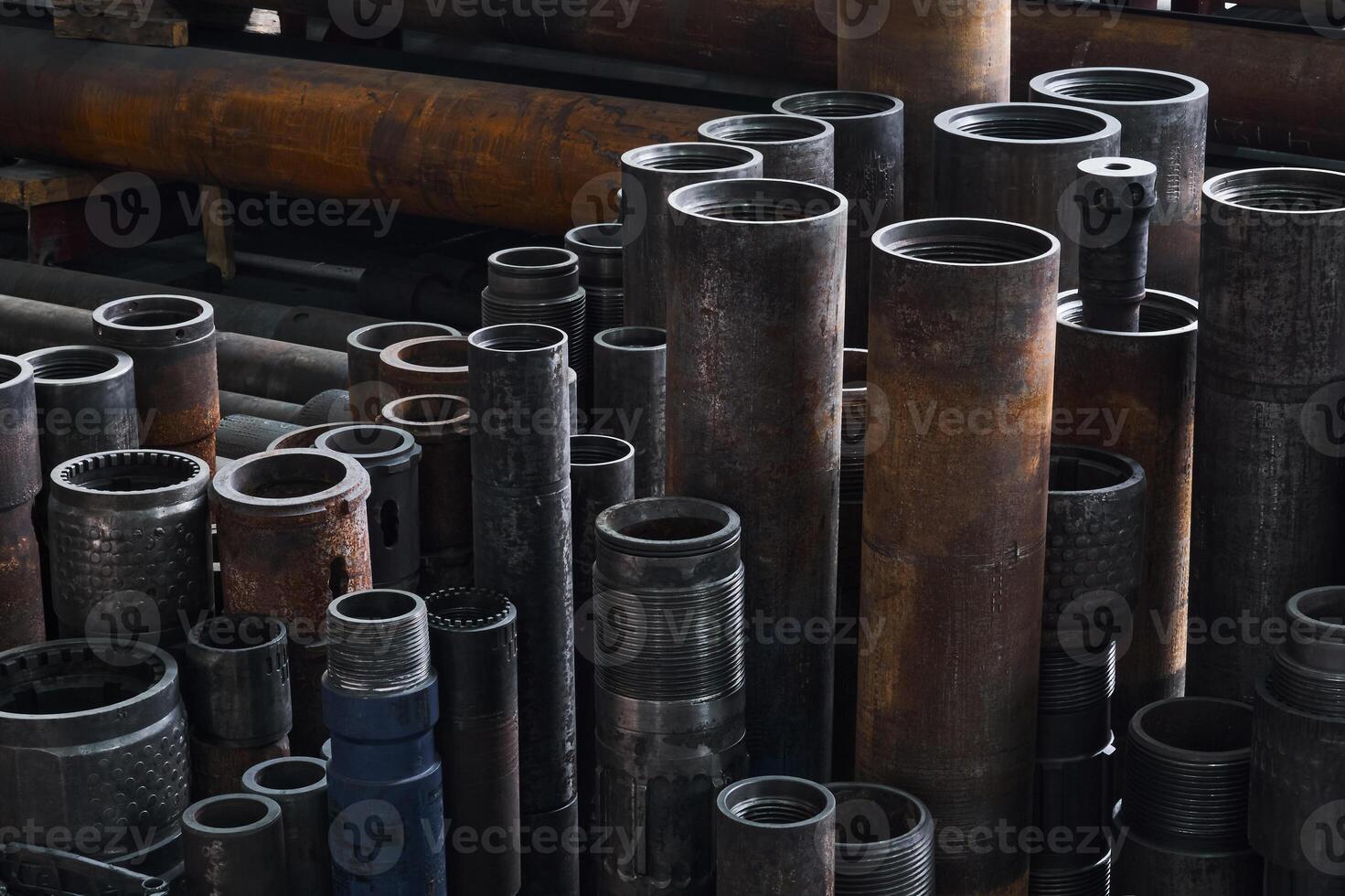 industrial background - rusty hardware, parts of turbodrills of various diameters are in the workshop photo