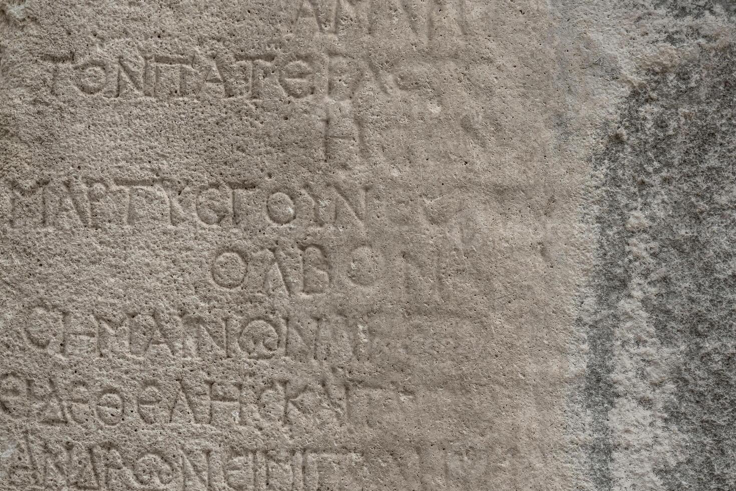 almost erased ancient Greek inscription on the stone photo