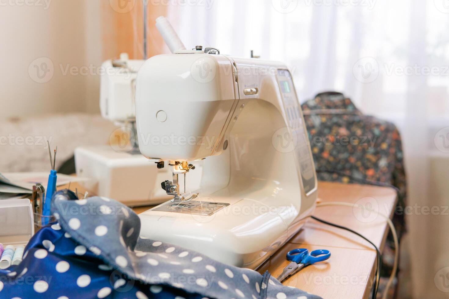 fabric and ready-to-use sewing machine on a table in a room photo