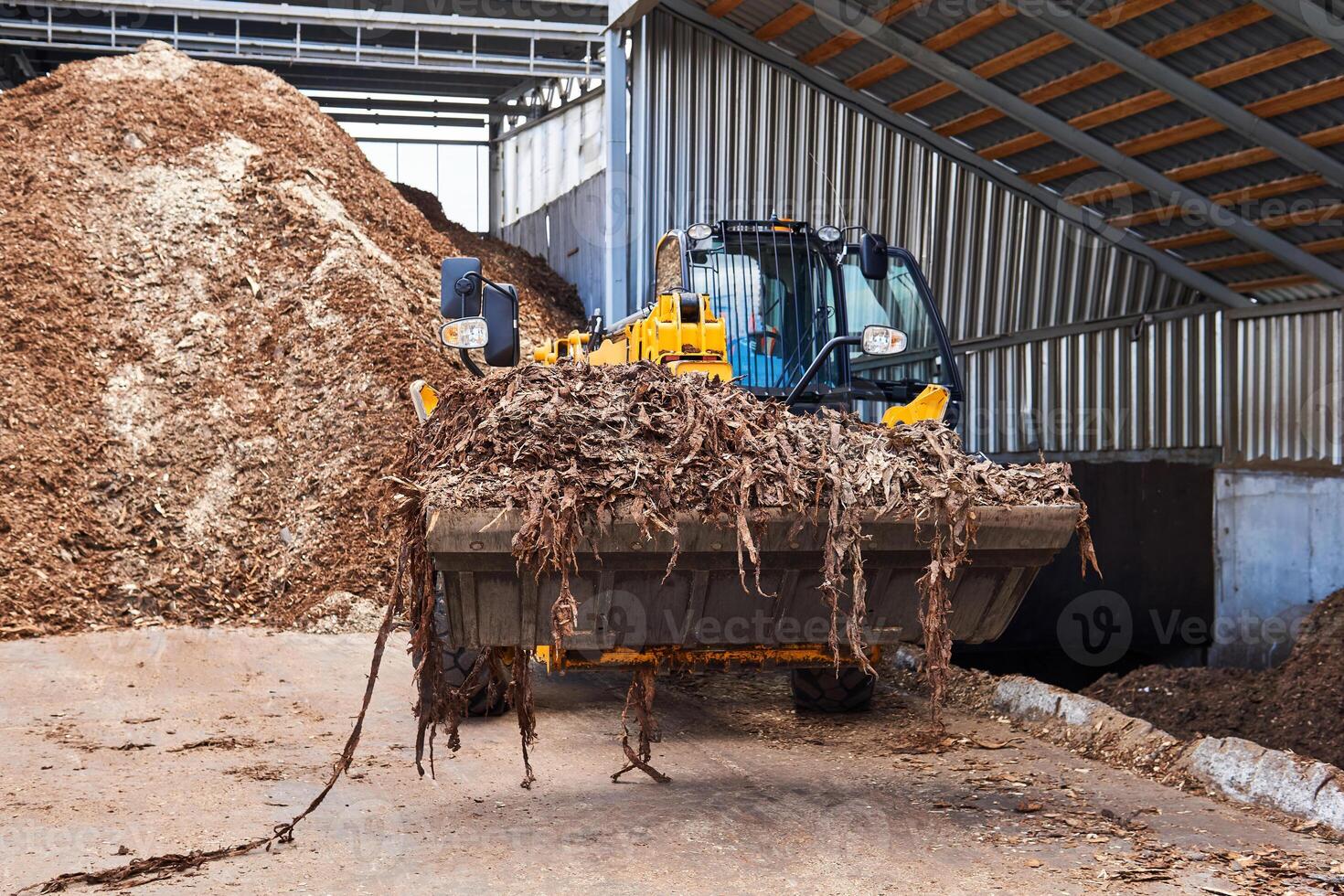 wheel loader with a bucket full of bark in the woodworking industry photo