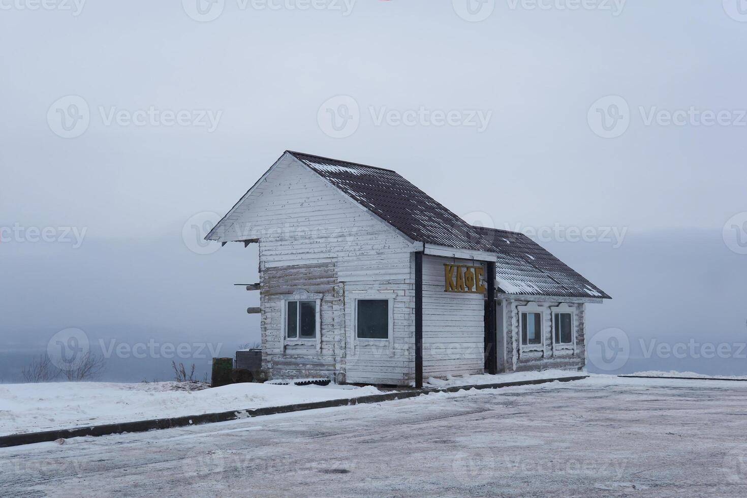 old wooden building of a transport cafe on a mountain pass in a snowy winter landscape in Perm Krai, Russia photo