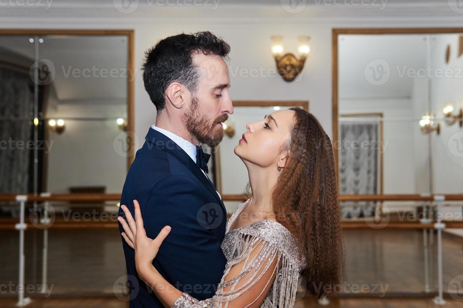 couple looks into each other's eyes while dancing photo