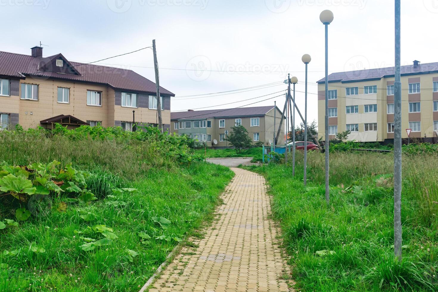 street in the village of Yuzhno-Kurilsk on Kunashir island with wooden two-story houses photo