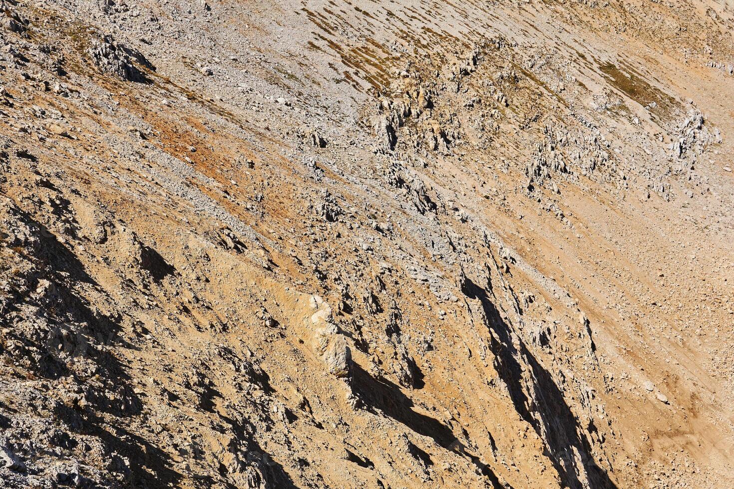 lifeless desert rocky mountainside with sharp rocks photo