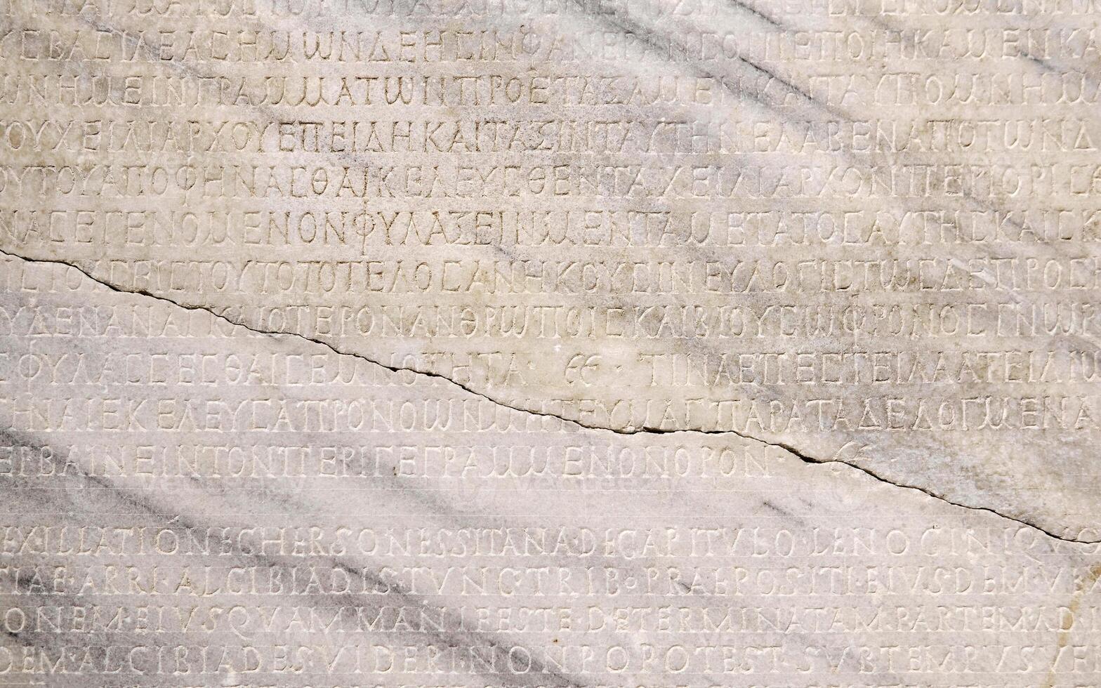 fragment of a marble slab with a carved text on the collection of taxes in ancient Greek from Chersonesos, Crimea photo