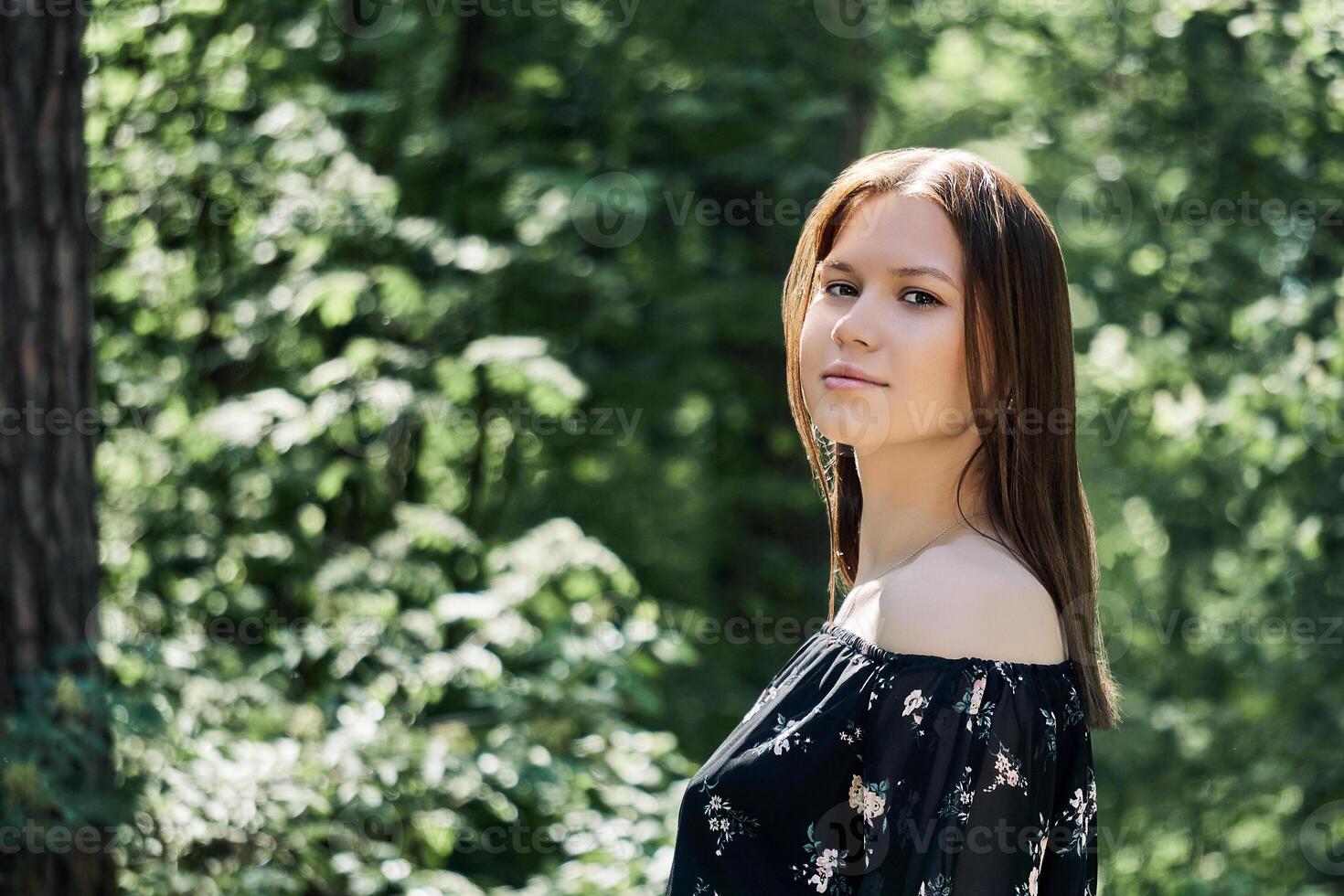 just a girl in a dress walks through the woods in spring photo