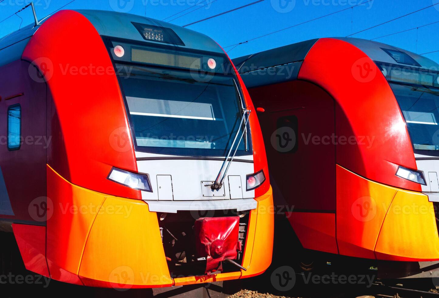 two suburban trains stand at the station photo