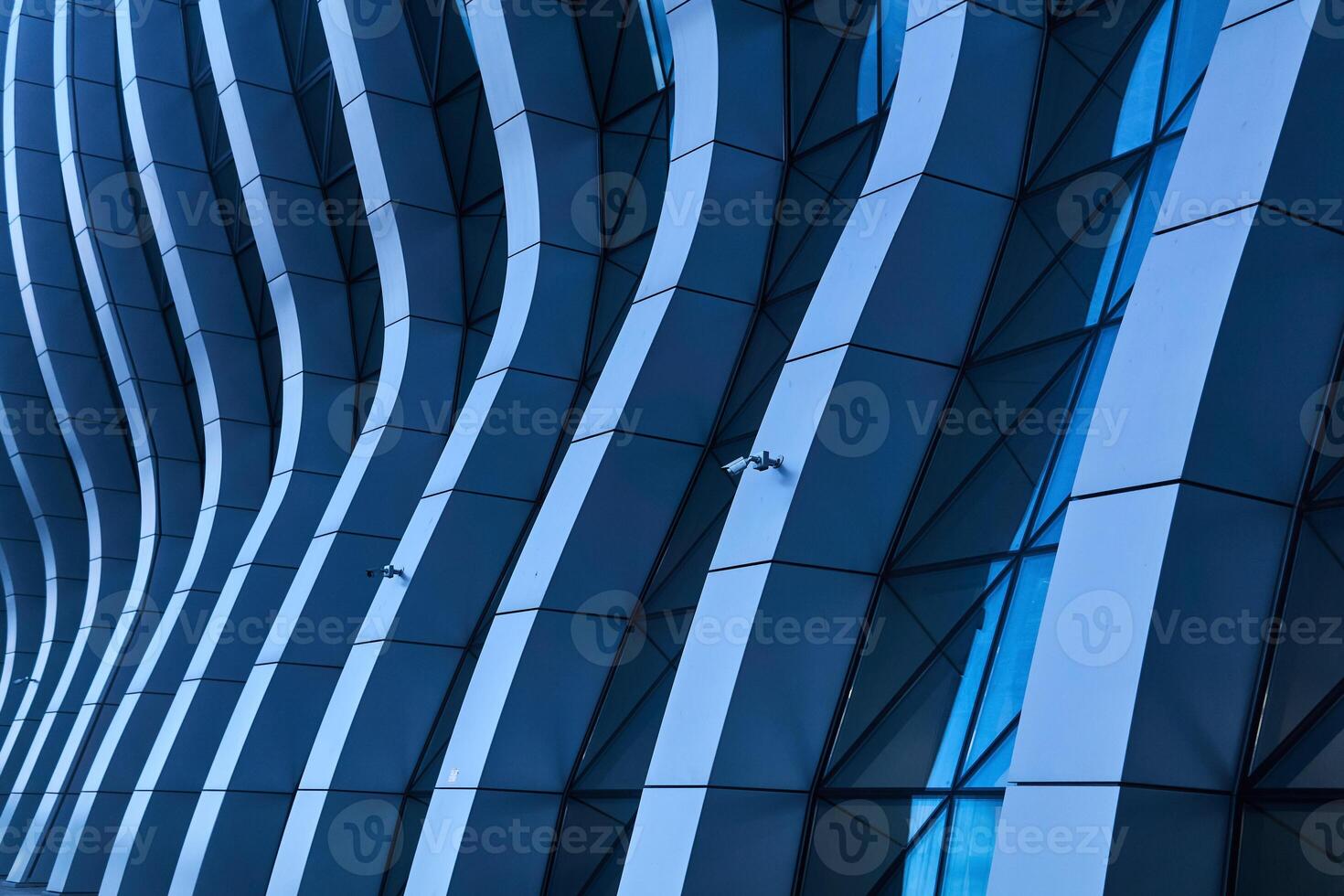 element of contemporary architecture - a fragment of the intricately curved facade of a modern building photo