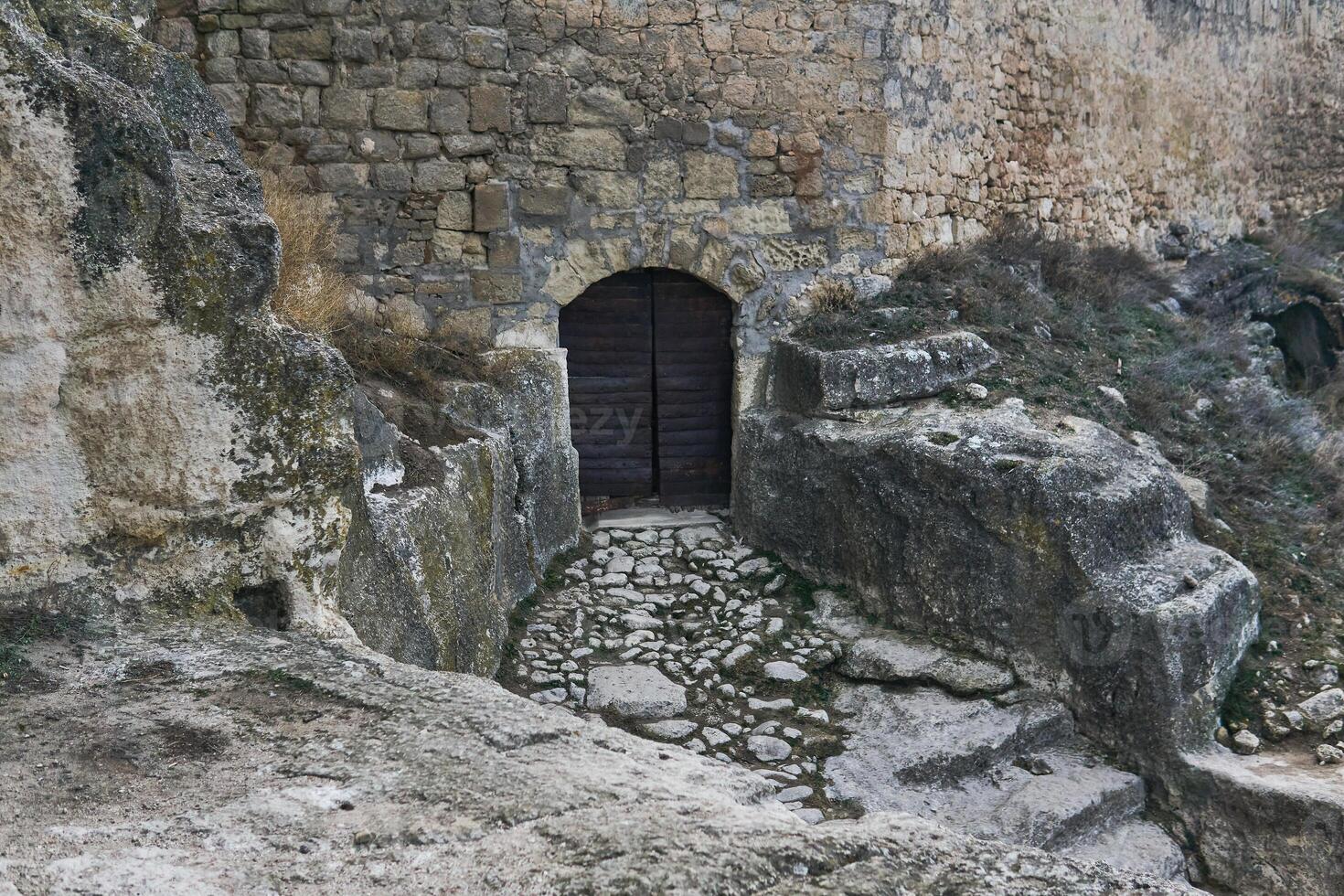 iron-clad gate to a medieval cave city-fortress photo
