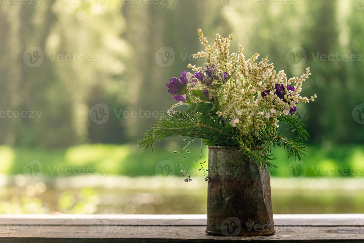 bouquet of wild plants in a rusty tin can photo