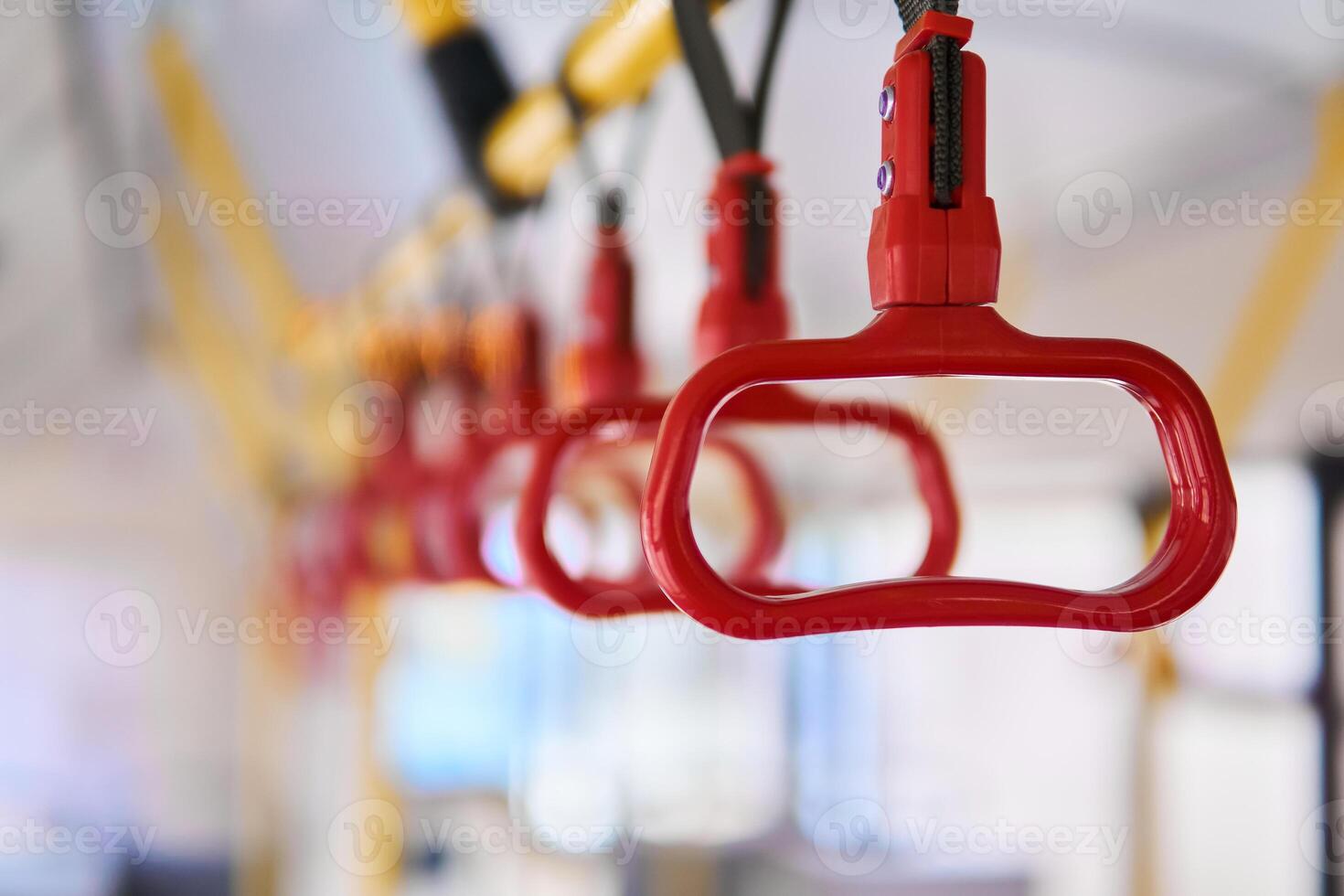grab handles in the passenger compartment of the bus on a blurred background photo