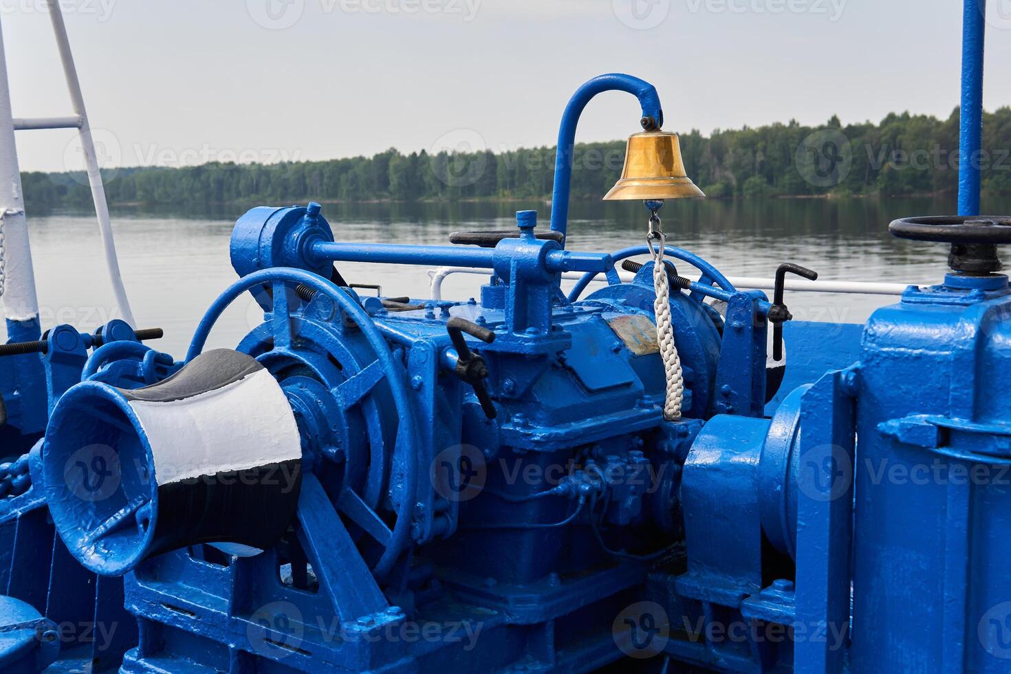 bell, capstan and other mechanisms, painted blue, on the foredeck of the river ship, close-up photo