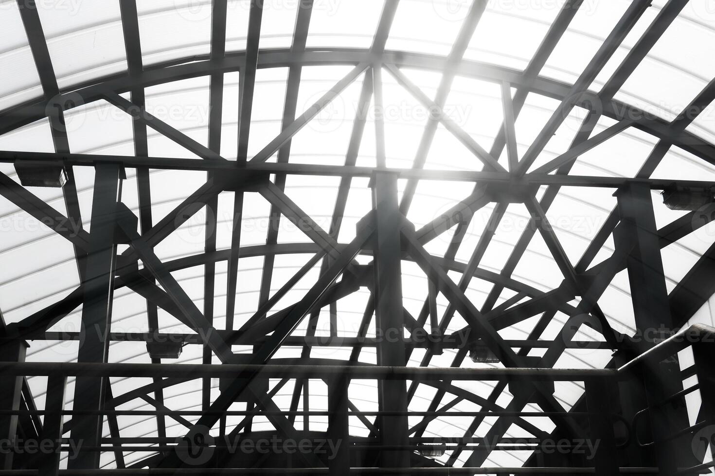 sun shines through the lattice structures of the covered pedestrian crossing photo