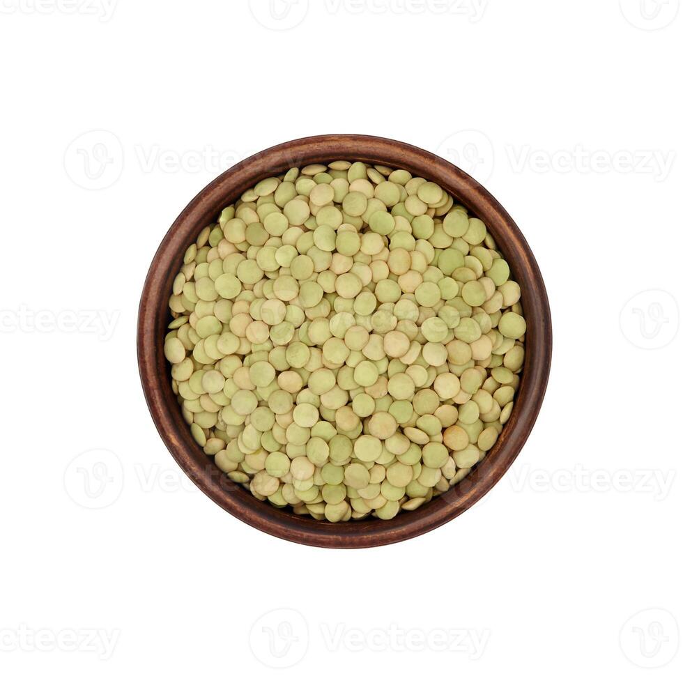 green lentils in clay bowl isolated on white background, top view photo