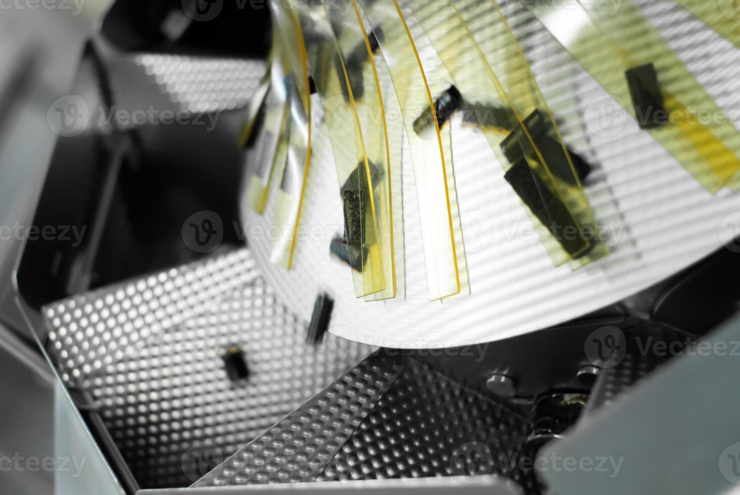 Close-up of a rotating detail of a packaging machine in a confectionery factory photo