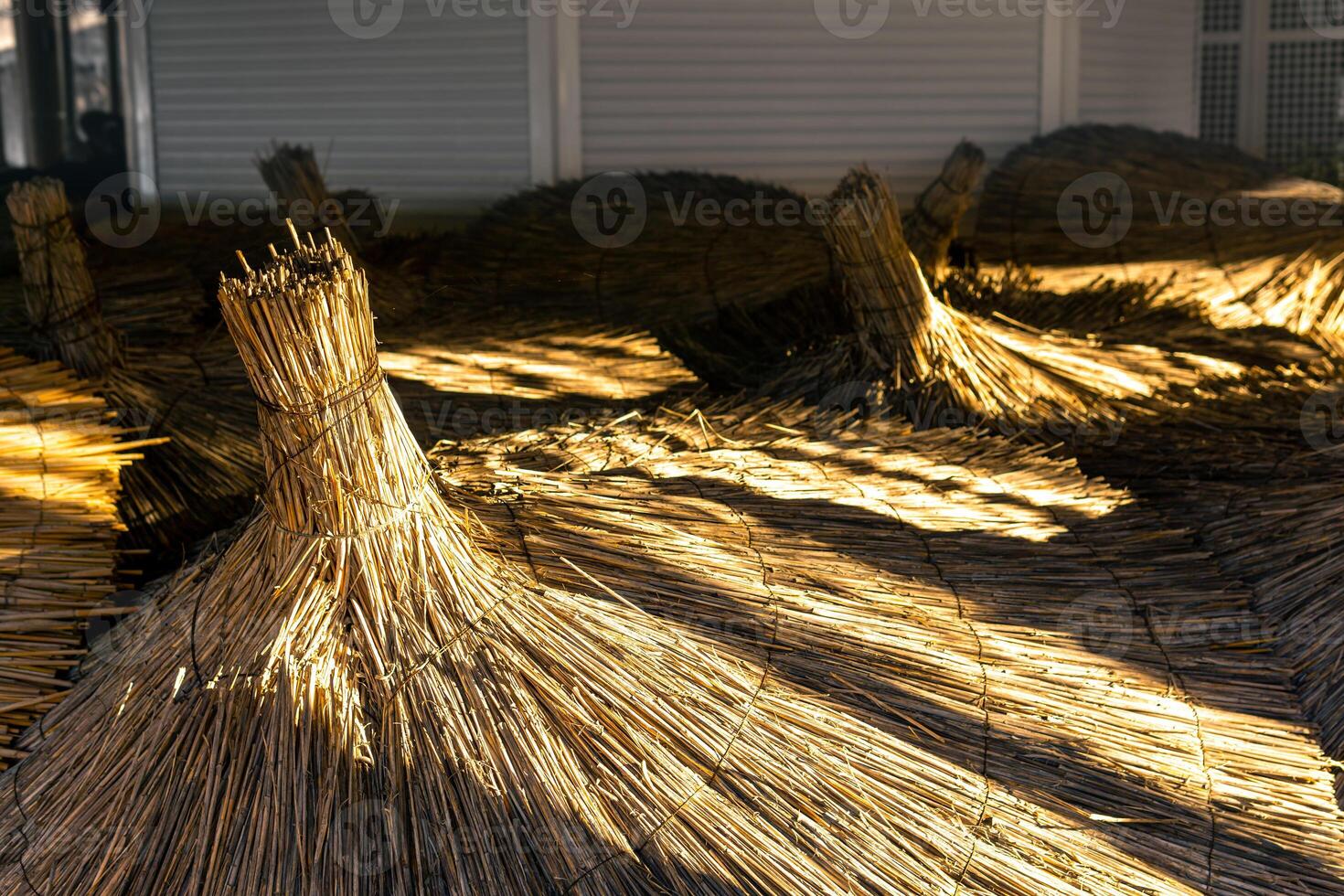 end of tourist season, thatched beach shelters put away for storage photo