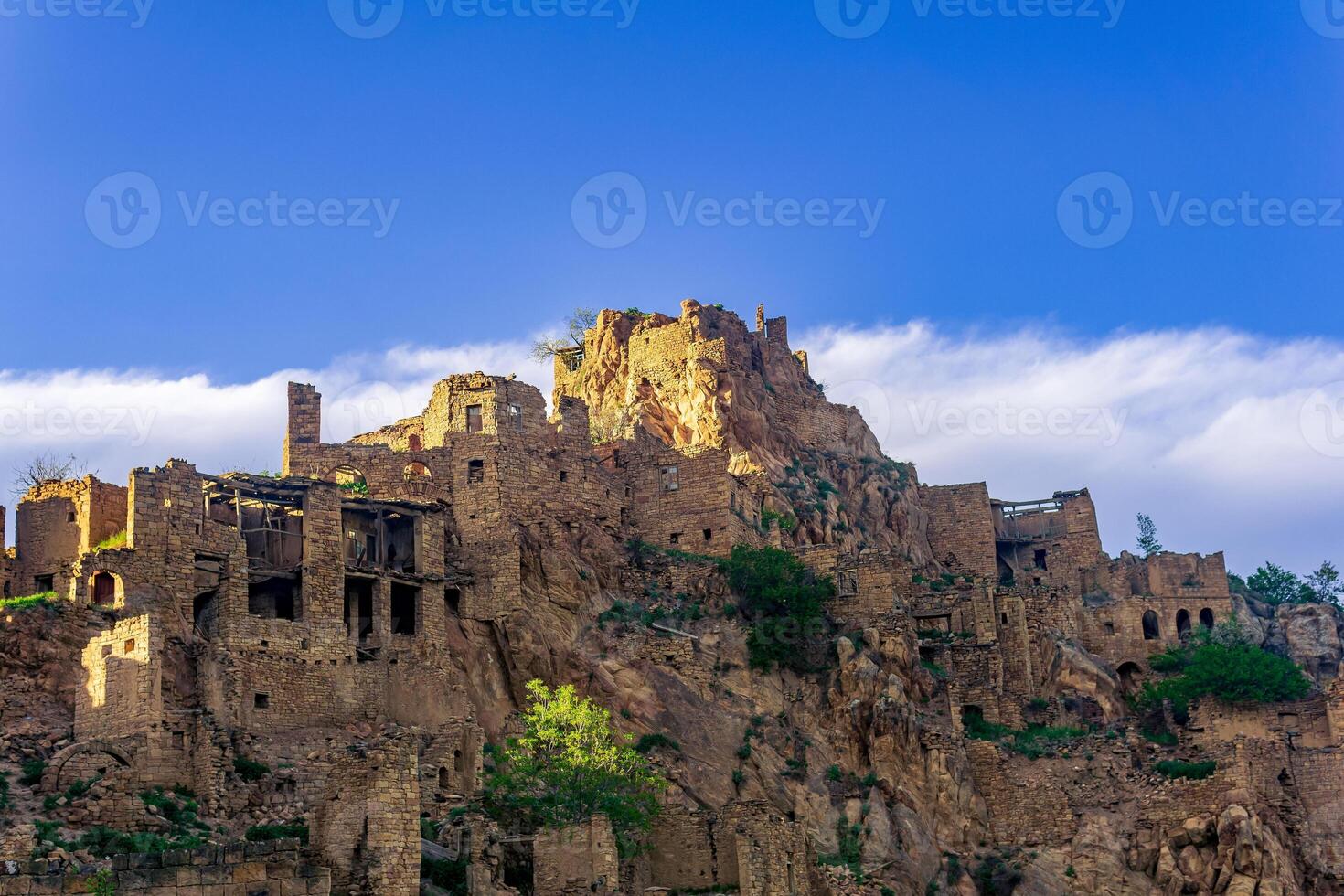 evening view of the abandoned village aul Gamsutl on top of a mountain in Dagestan photo