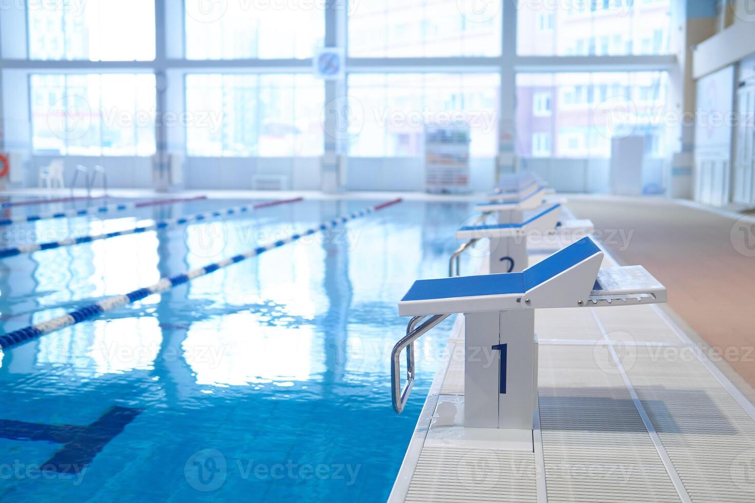 fragment of the interior of an indoor sports pool with a row of diving boards photo