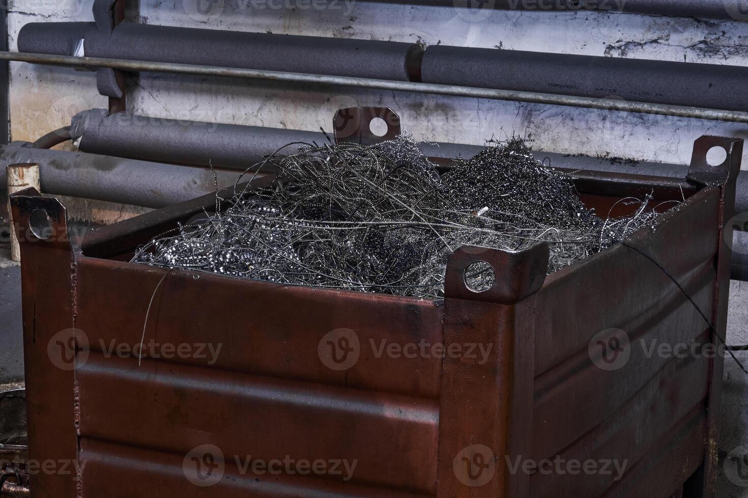 box with metal shavings - waste from turning production photo