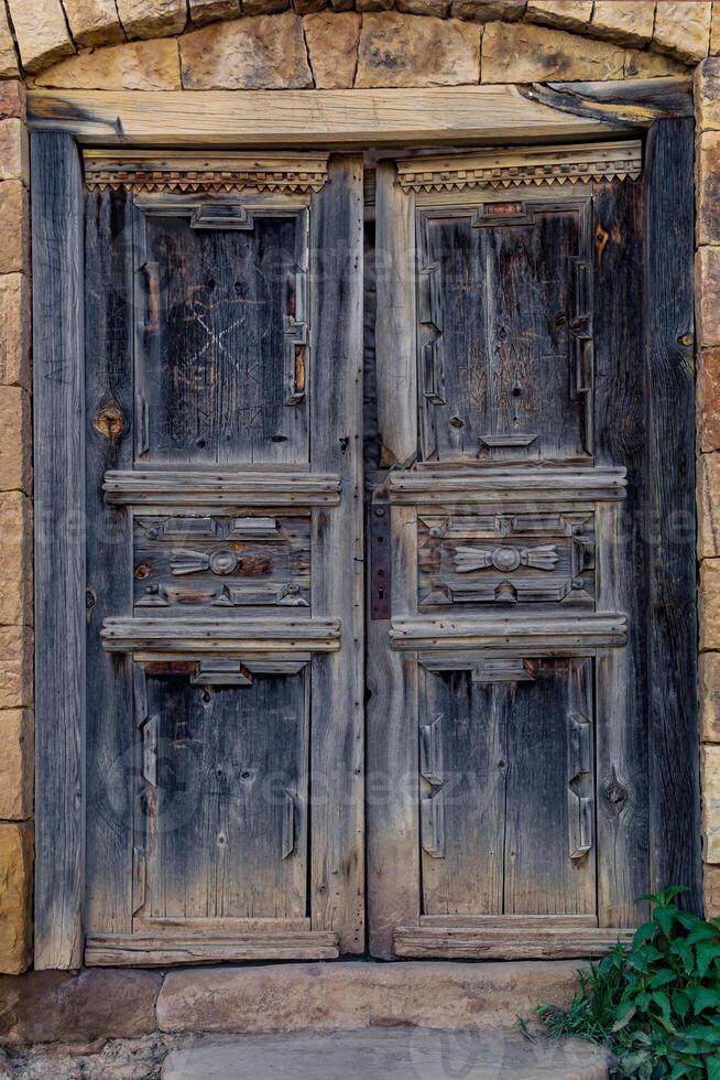 ancient wooden doors in the ruins of the abandoned village of Gamsutl, Dagestan photo