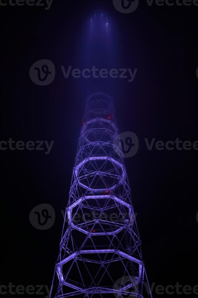lattice TV tower hiding in the night fog photo