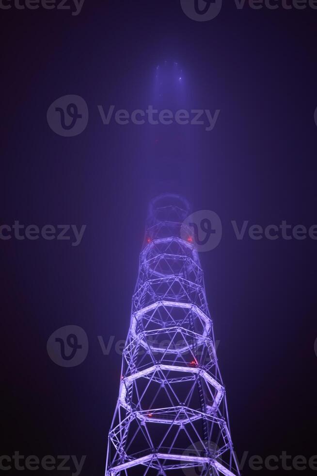 lattice TV tower hiding in the night fog photo