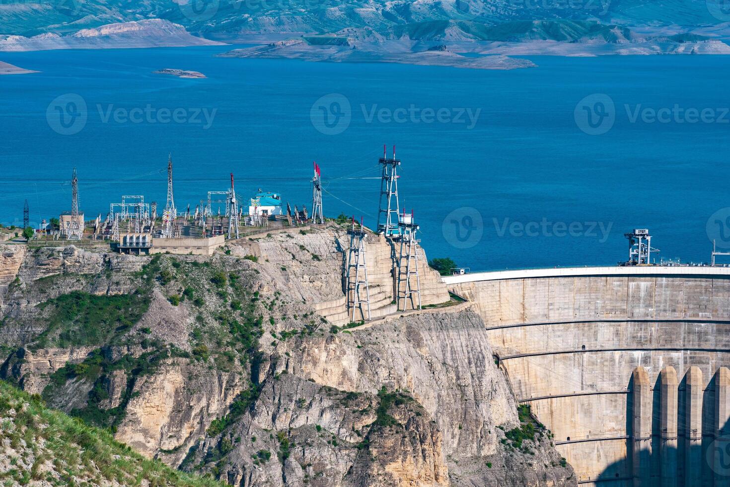 upper part of huge arch dam of the hydroelectric power station and the electrical substation in a high mountain canyon, the Chirkeyskaya HPP in Dagestan photo