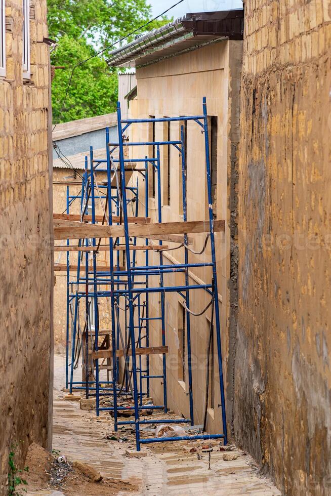 restoration of a historic building in the old quarter, scaffolding next to the old house photo