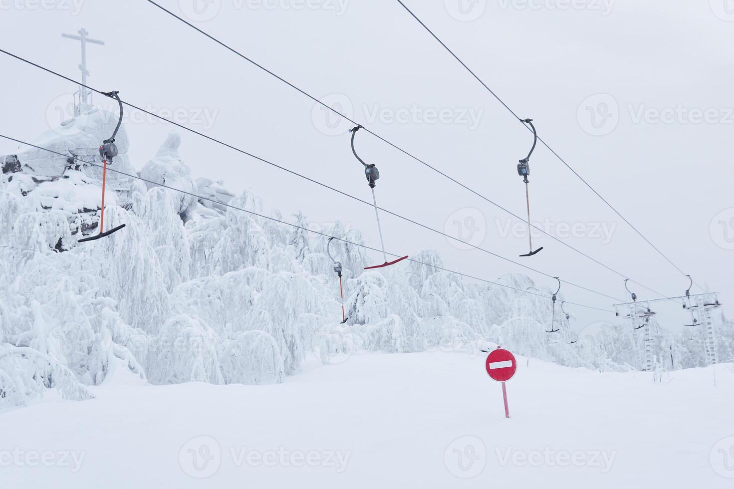 prohibitory road sign No entry against the background of an empty ski surface lifts on a snowy ski slope photo