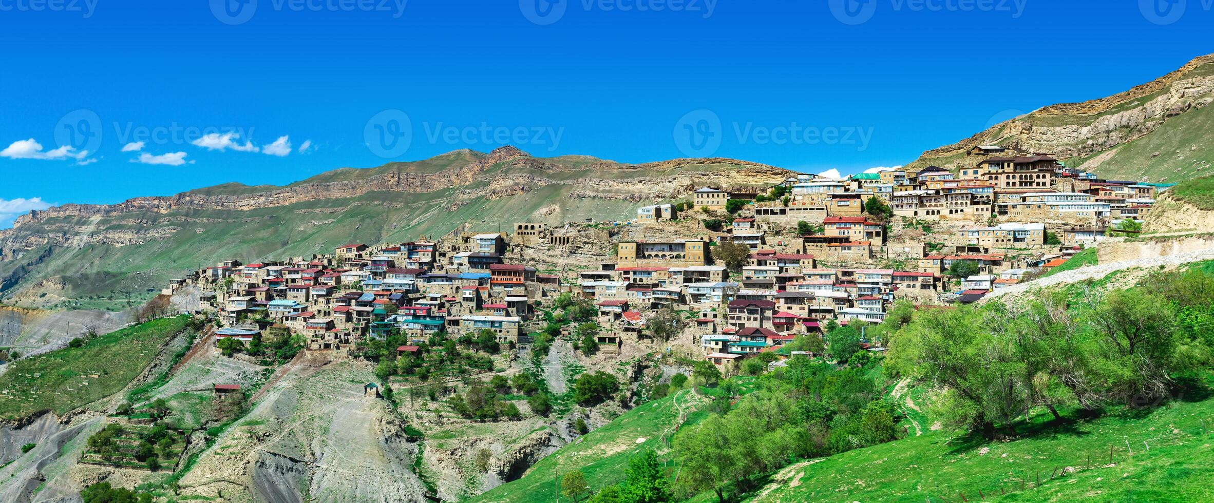 panorama of the entire ancient mountain village Chokh on a rocky slope in Dagestan photo