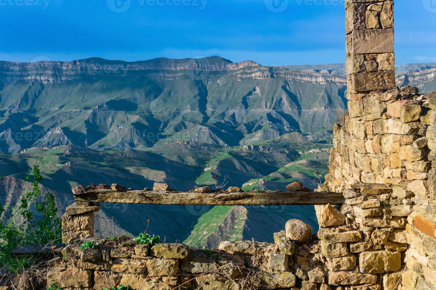 bench over an abyss in the ruins of the historic mountain village of Gamsutl in Dagestan photo
