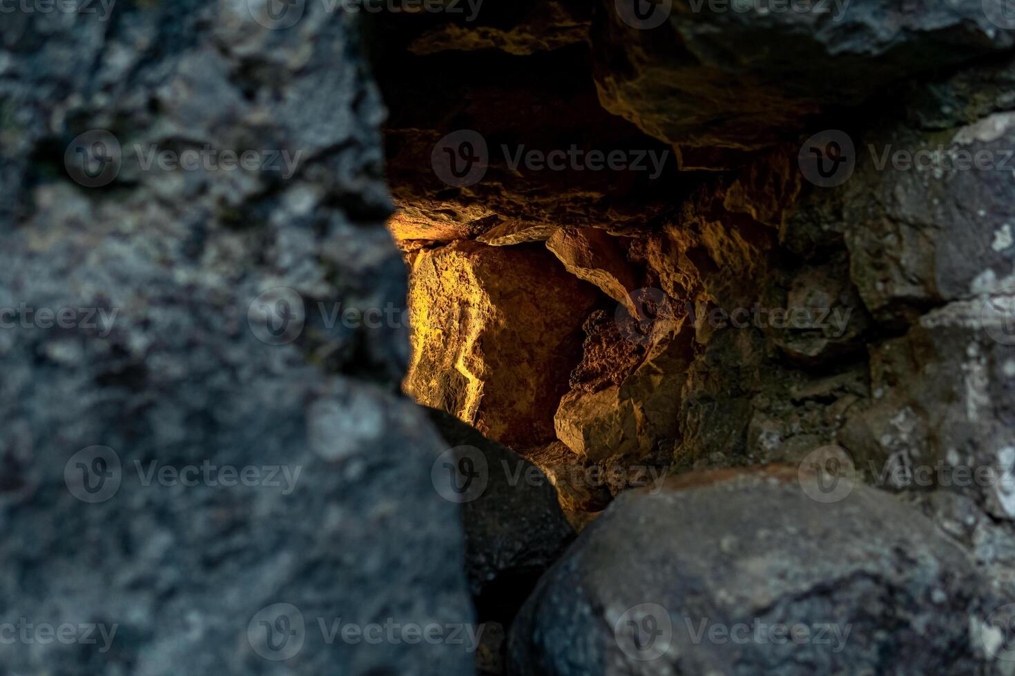 embrasure in the old fortress wall through which light breaks, close-up photo