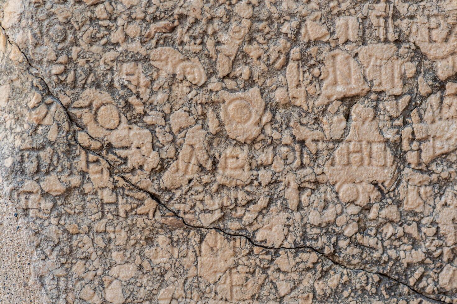 background - half-erased antique inscription on a stone in Phaselis, Turkey photo