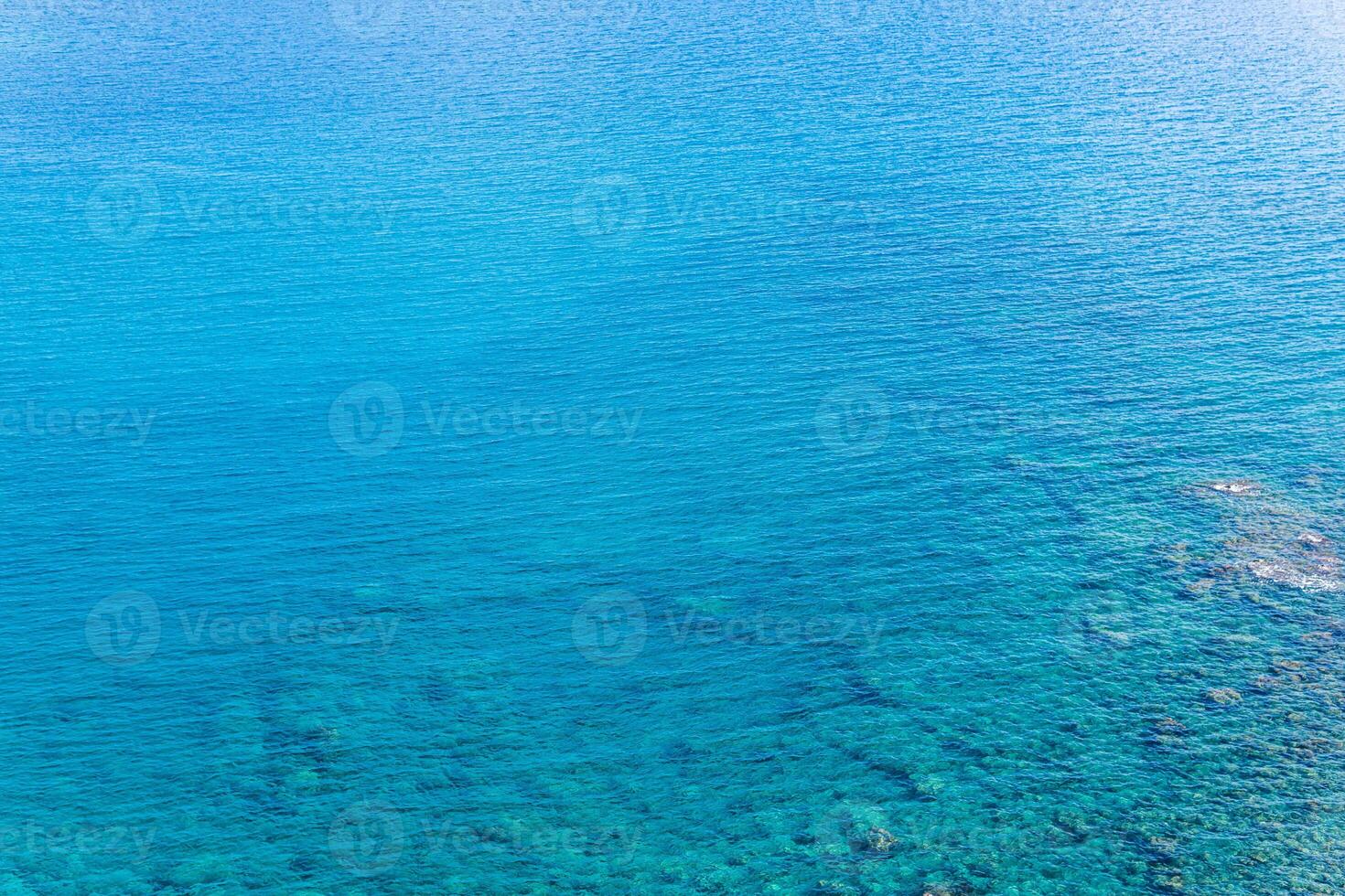 marine background, transparent blue coastal littoral over coral reef photo
