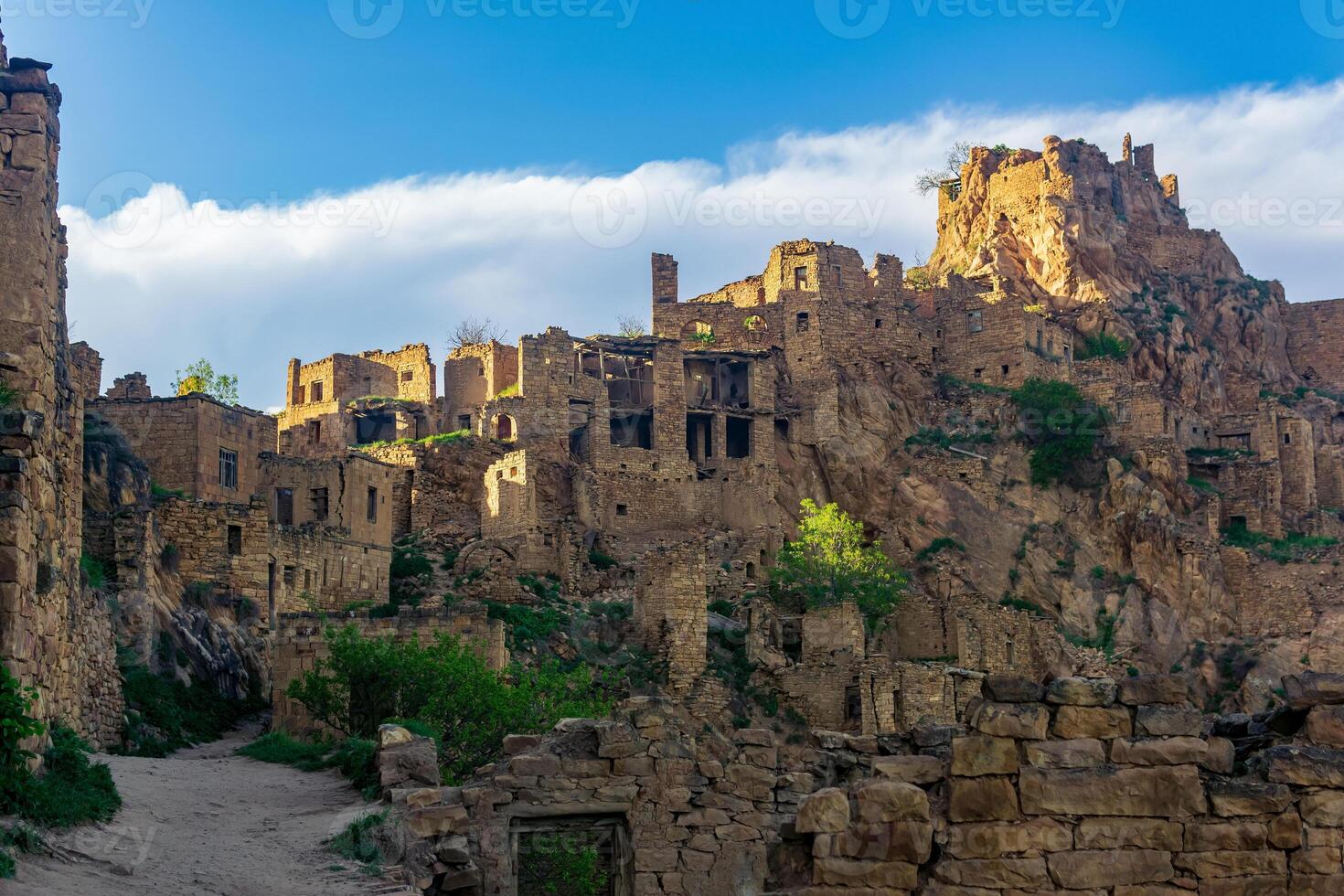 evening view of the uninhabited village of Gamsutl on top of a mountain in Dagestan photo