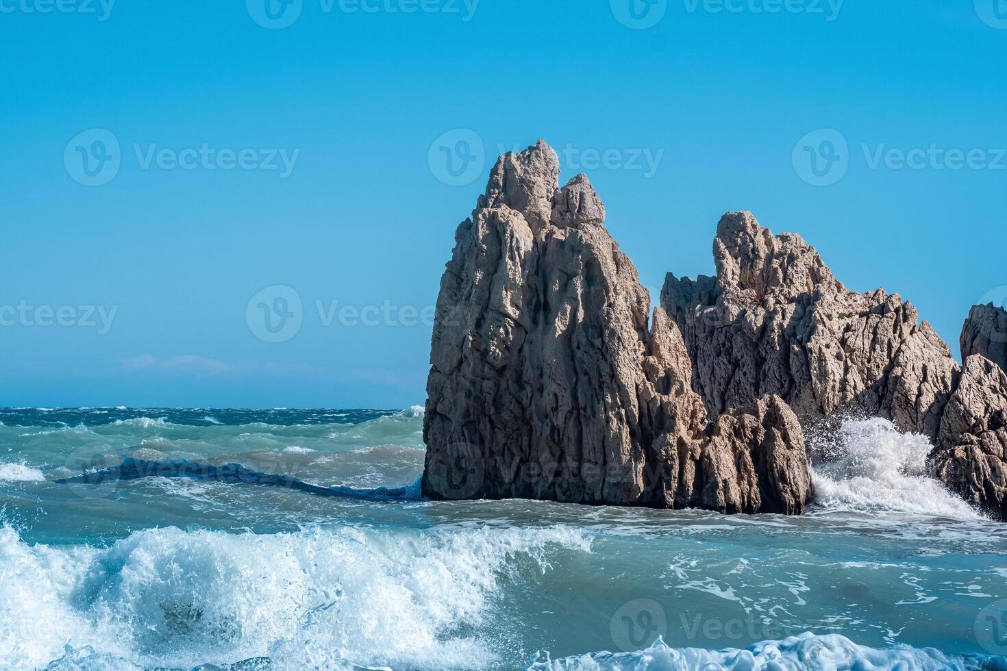 sea coastal cliffs among surf on a windy sunny day photo