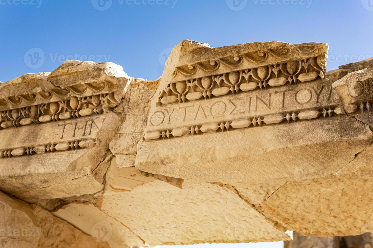 ancient Greek ruins with stone-cut ornament and inscription against the sky in Myra, Turkey photo