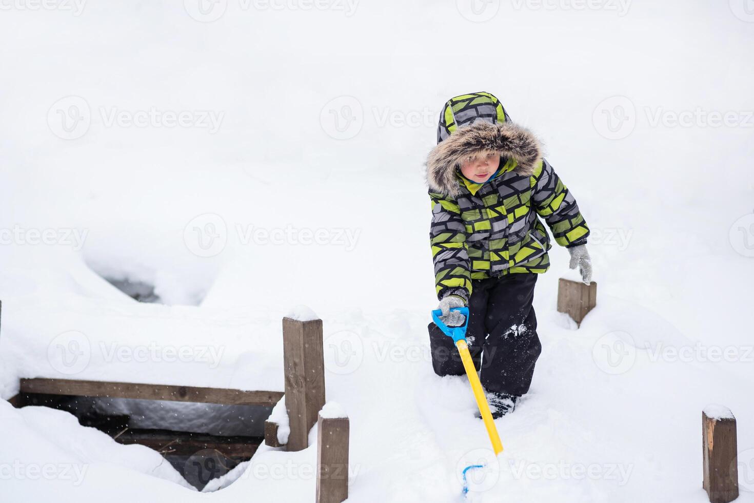 little child walking in winter snowy park photo