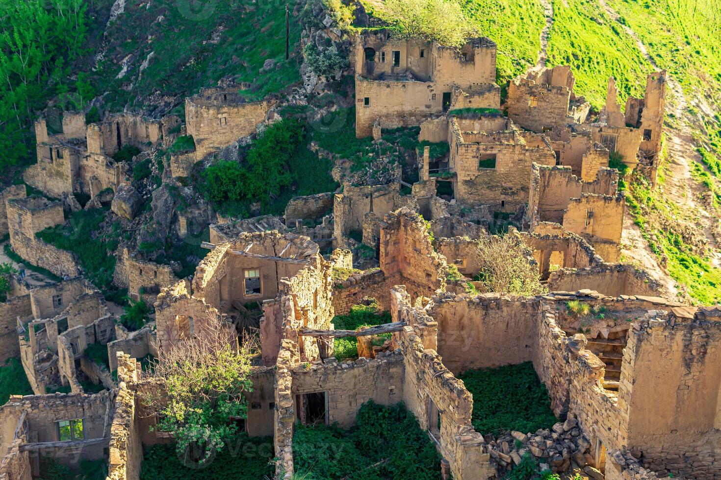top view of the ruins of the buildings of the uninhabited village of Gamsutl in Dagestan photo