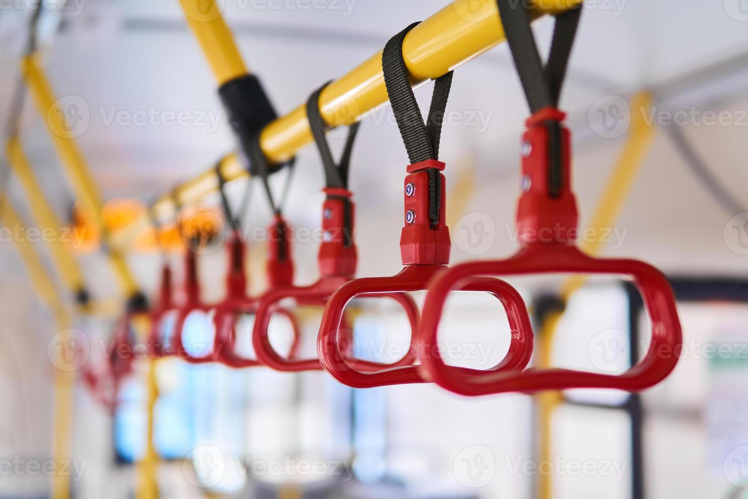 grab handles in the passenger compartment of the bus on a blurred background photo