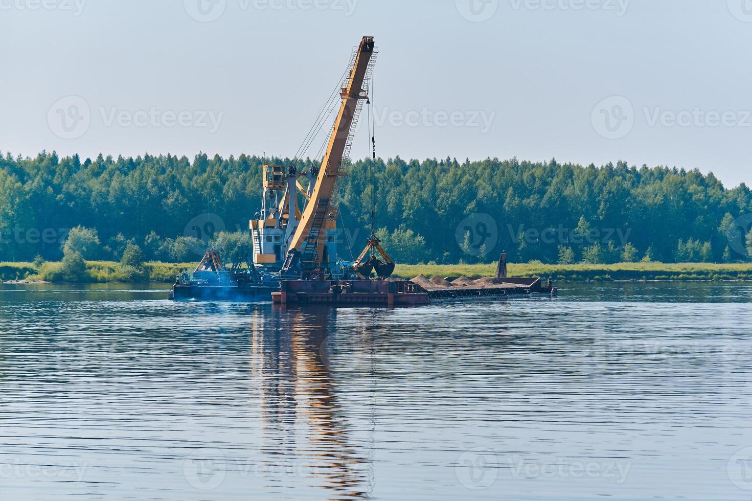 dredger is working to deepen the fairway on the river photo